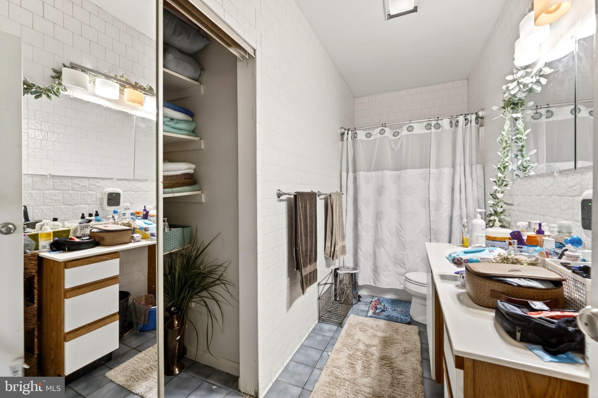 131 Midland Road Glen Burnie, MD 21060 - Photo 26 of 44 a kitchen with stainless steel appliances a stove a chimney and a refrigerator