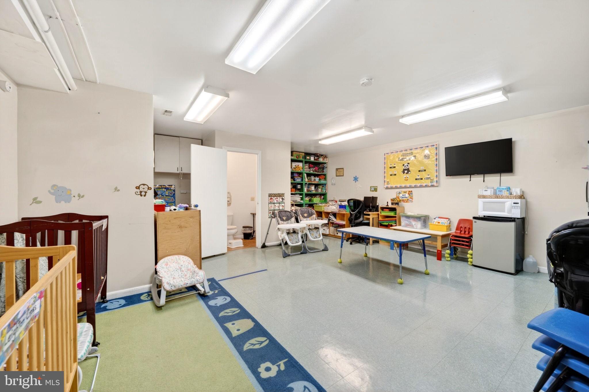 131 Midland Road Glen Burnie, MD 21060 - Photo 35 of 44 a living room with furniture a window and a flat screen tv