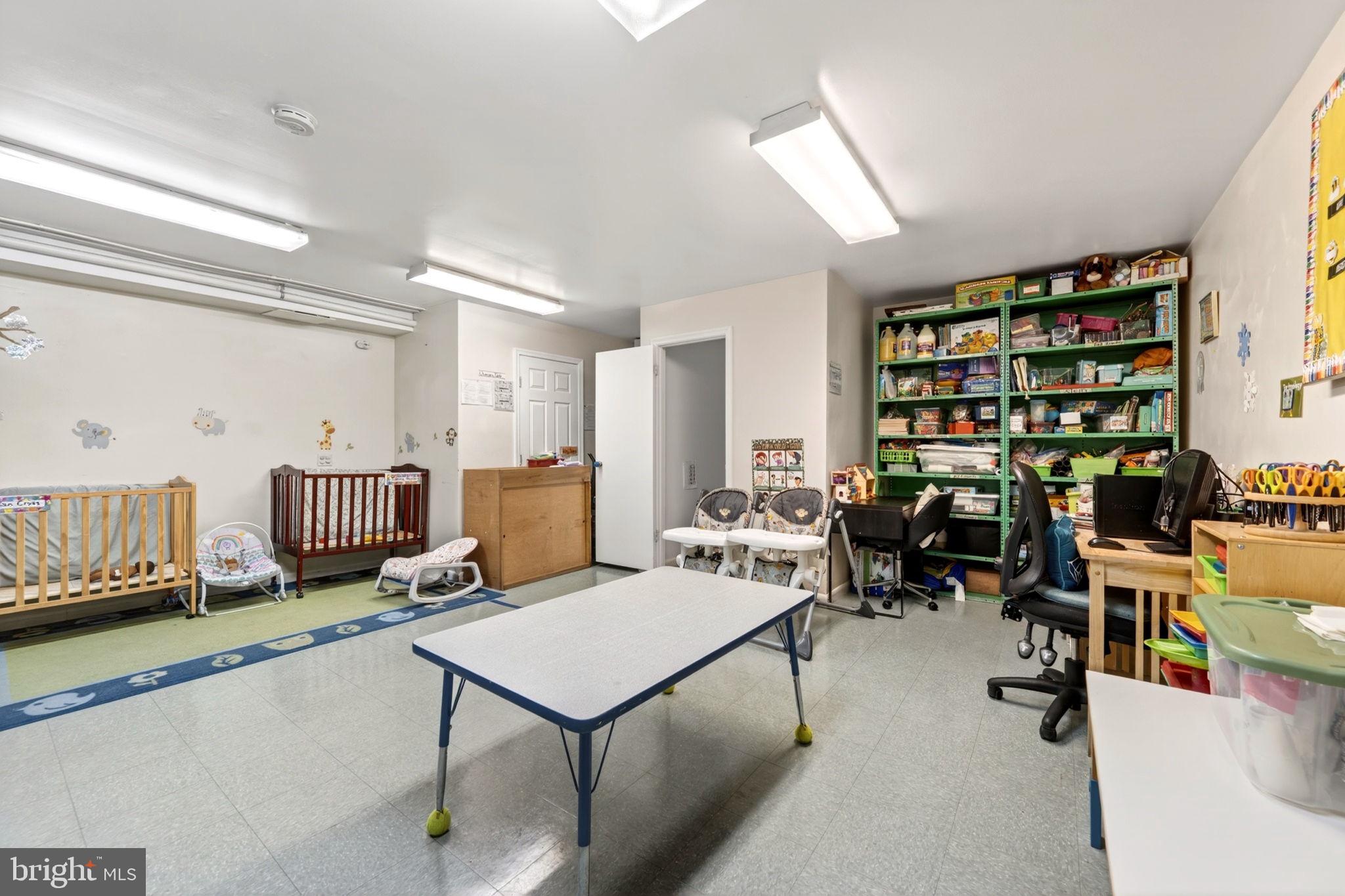 131 Midland Road Glen Burnie, MD 21060 - Photo 36 of 44 a living room with furniture a rug and a book shelf