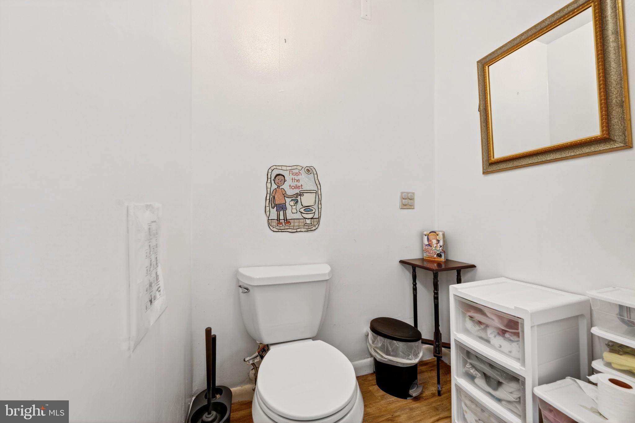 131 Midland Road Glen Burnie, MD 21060 - Photo 37 of 44 a white toilet sitting next to a bathroom sink