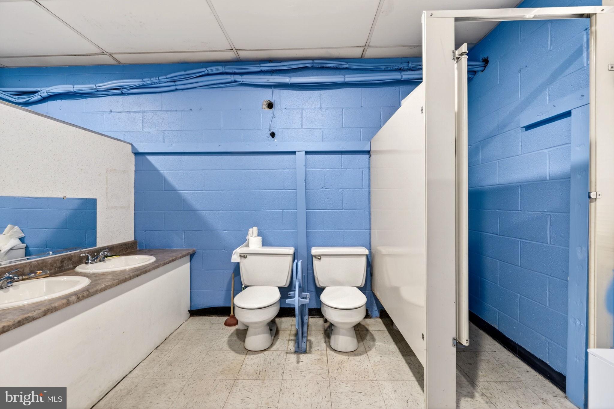 131 Midland Road Glen Burnie, MD 21060 - Photo 7 of 44 a bathroom with a toilet a sink and mirror