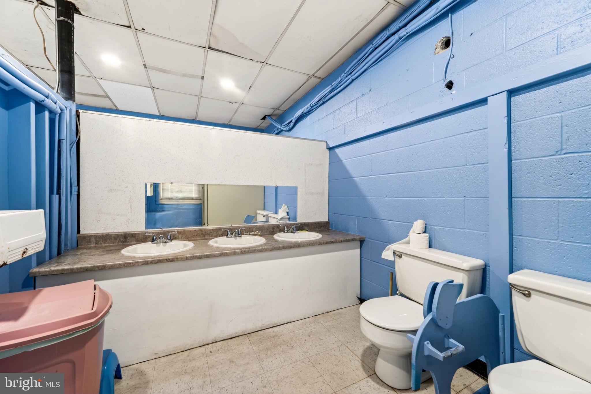 131 Midland Road Glen Burnie, MD 21060 - Photo 8 of 44 a bathroom with a granite countertop toilet sink and mirror