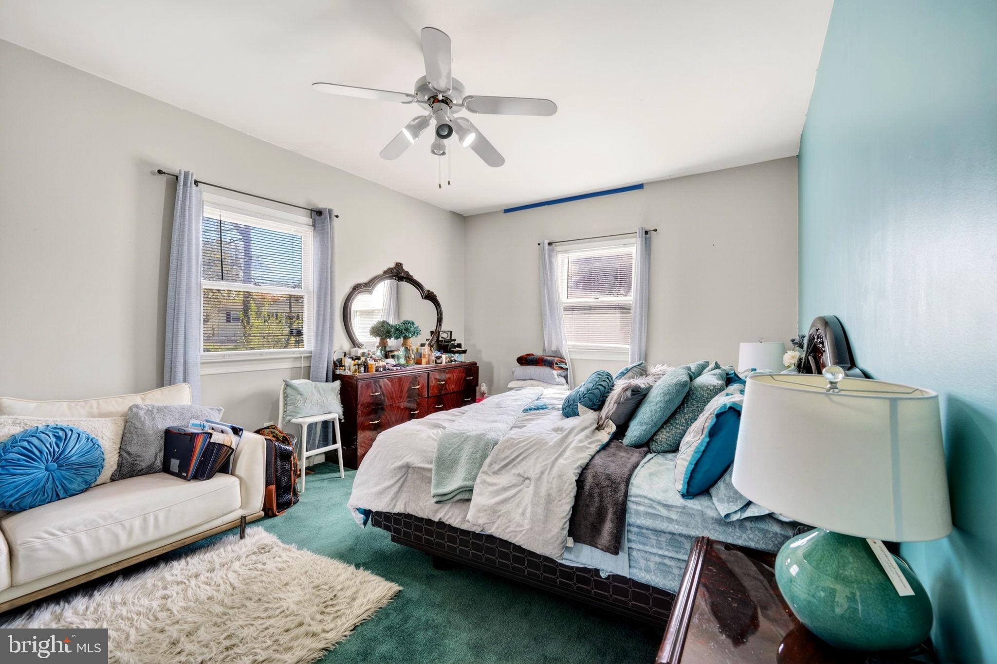 131 Midland Road Glen Burnie, MD 21060 - Photo 9 of 44 a bedroom with a bed a couch and dresser