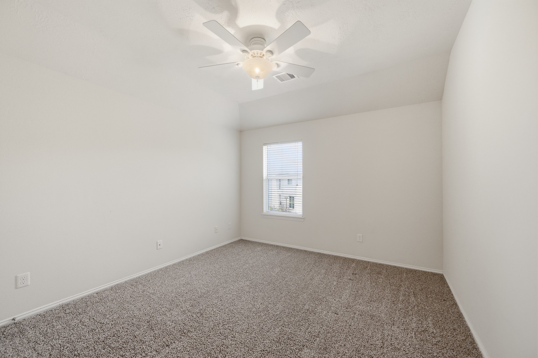 2117 Rushing Spring Drive Pearland, TX 77584 - Photo 38 of 42 Bedroom 4 offers a cozy and serene retreat with plush carpeting, soft neutral walls, and a ceiling fan for comfort.