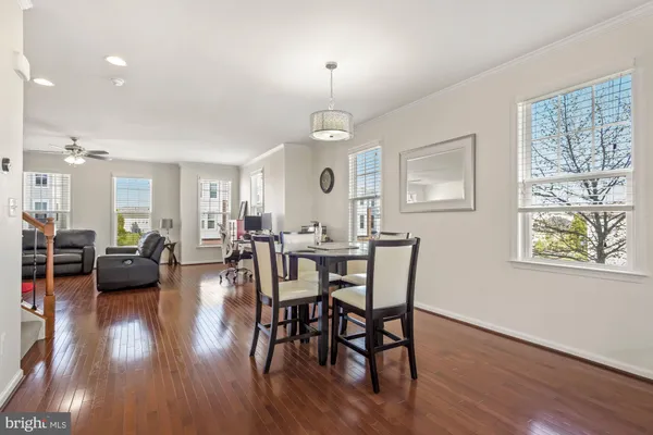 a view of a a dining room with furniture window and wooden floor