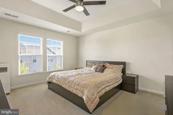 a bedroom with a bed lamp and window