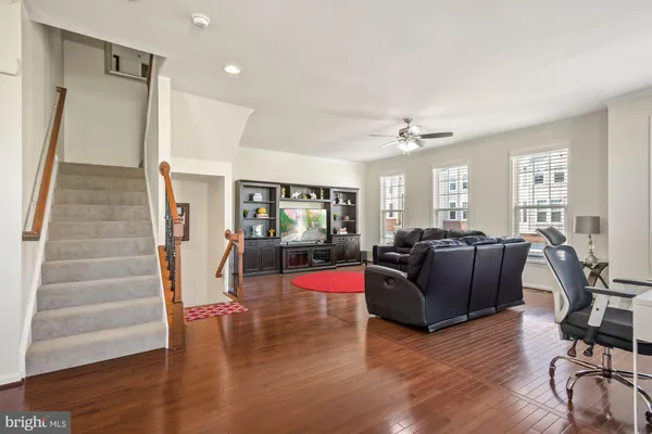 a living room with furniture window and wooden floor