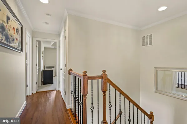 a view of a hallway with wooden floor and entryway