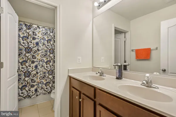 a bathroom with a double vanity sink and a mirror