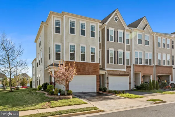a front view of a residential apartment building with a yard