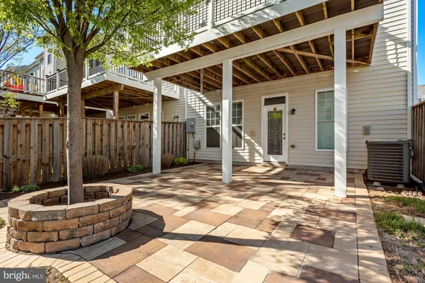 a view of house with backyard and glass windows