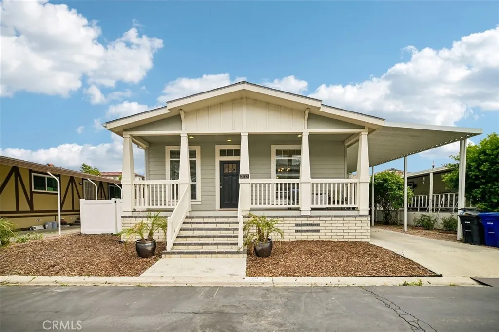 250 East Telegraph Road, Unit 307 Fillmore, CA 93015 - Photo 1 of 36 a front view of a house with a yard and garage