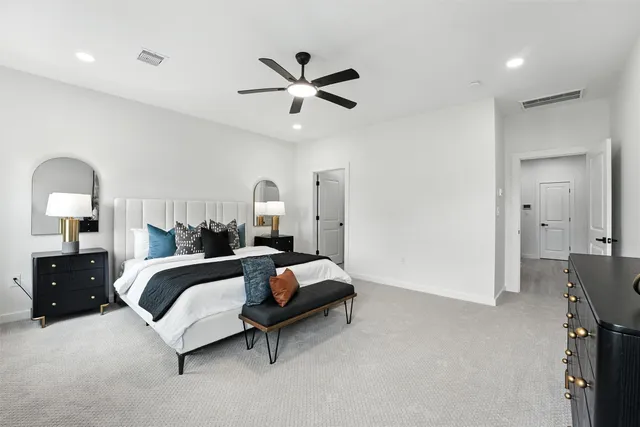 a spacious bedroom with a bed and window