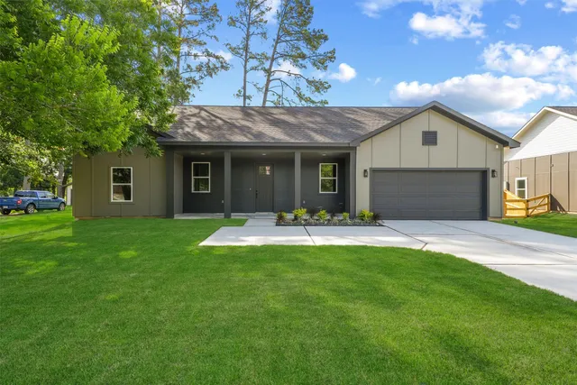 a front view of house with yard and outdoor seating
