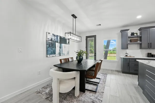 a kitchen with a sink cabinets and wooden floor