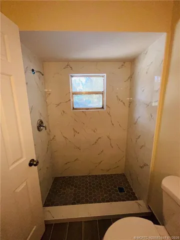a bathroom with a granite countertop shower