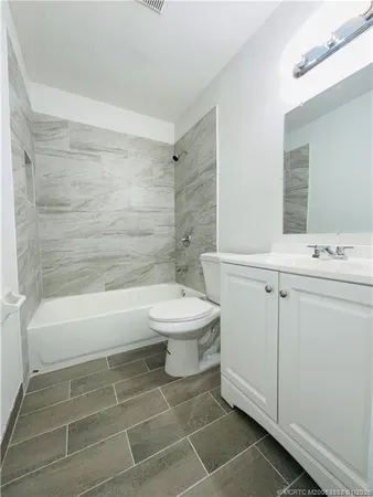 a bathroom with a toilet a sink and bathtub