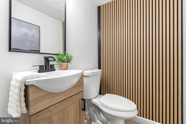 a bathroom with a sink a toilet and mirror