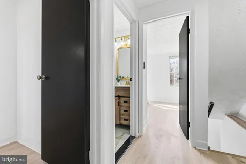 a view of a hallway with wooden shelves