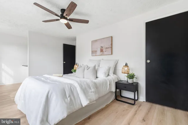 a bedroom with a bed and a table