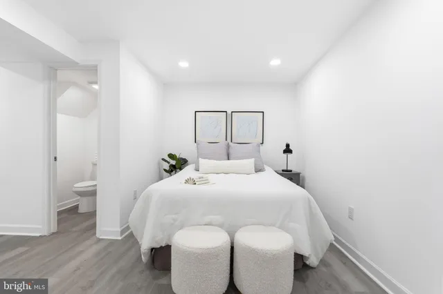 a bedroom with a bed and a mirror