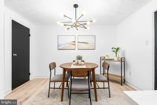 a dining room with furniture and chandelier