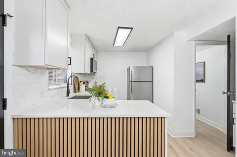 a kitchen with refrigerator and cabinets