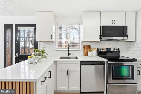 a kitchen with a sink stove and microwave