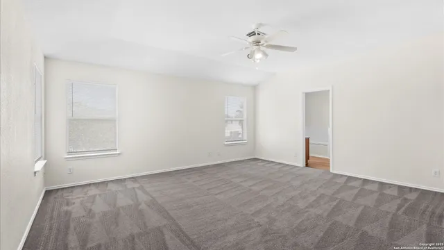 a view of an empty room with a fan