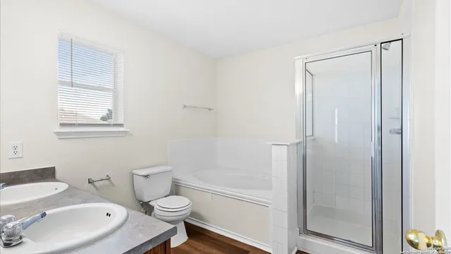 a white toilet sitting next to a bathroom sink