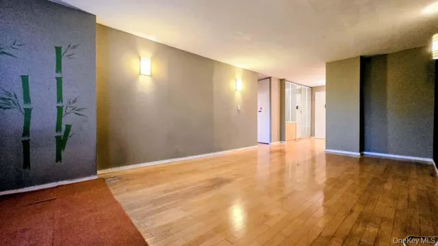 a view of a room with wooden floor and a ceiling fan