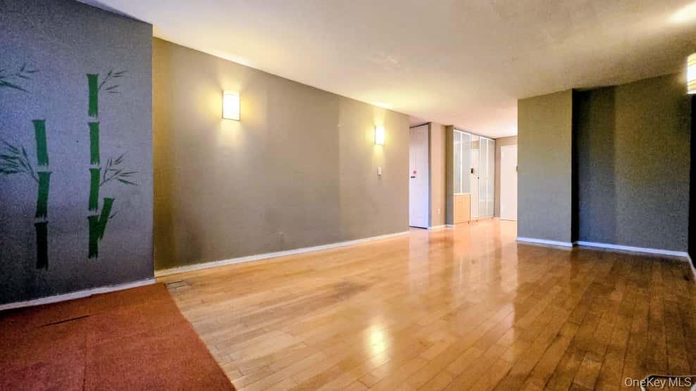 118-18 Union Turnpike, Unit 4B Queens, NY 11415 - Photo 11 of 30 a view of an empty room with wooden floor