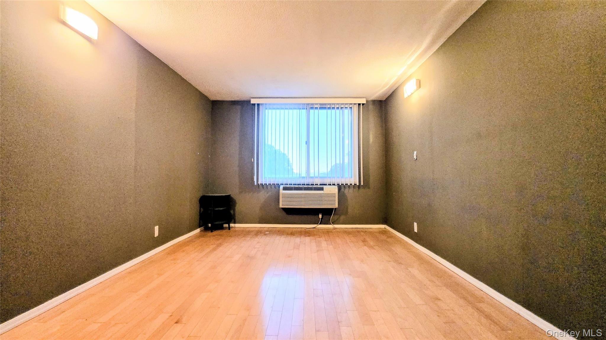 118-18 Union Turnpike, Unit 4B Queens, NY 11415 - Photo 20 of 30 a bedroom with a bed and a window