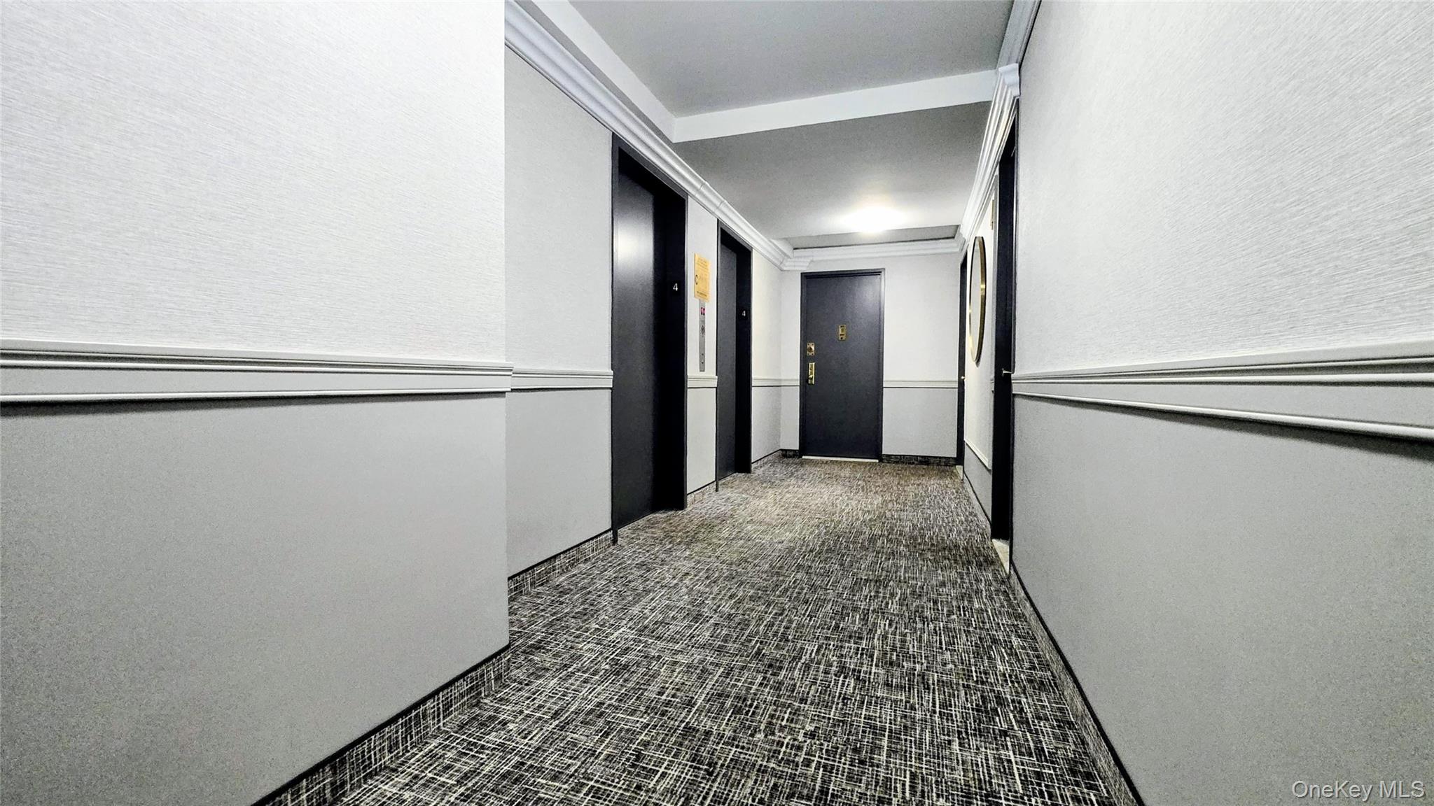 118-18 Union Turnpike, Unit 4B Queens, NY 11415 - Photo 26 of 30 a view of hallway with closet and a window