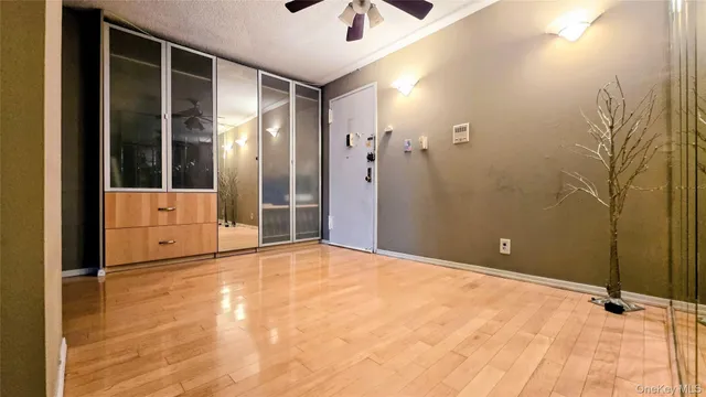 a view of a room with wooden floor and windows