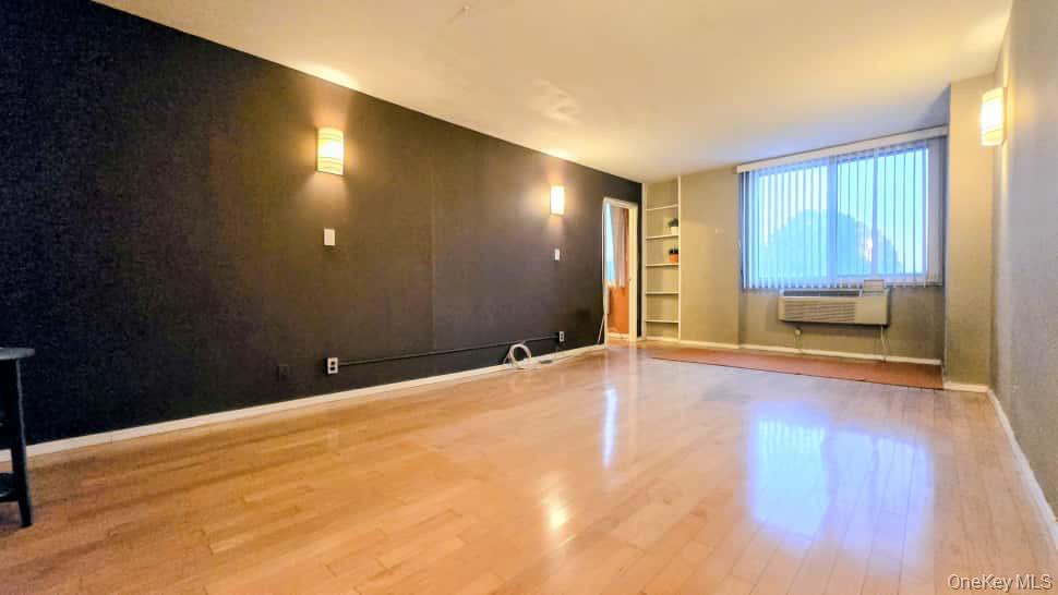 118-18 Union Turnpike, Unit 4B Queens, NY 11415 - Photo 7 of 30 a view of a room with wooden floor and windows