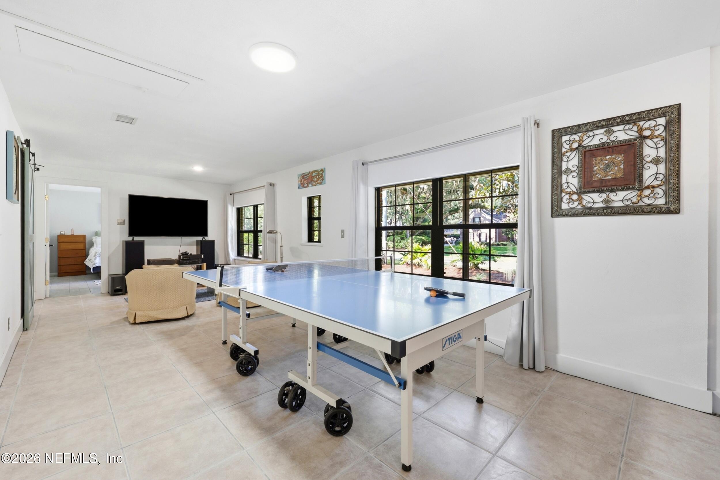 11627 Mandarin Terrace Road Jacksonville, FL 32223 - Photo 40 of 79 a room with table chairs and flat screen tv