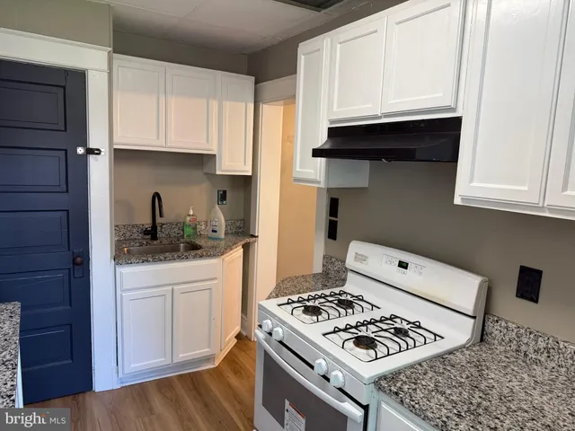 a kitchen with a sink and wooden cabinets