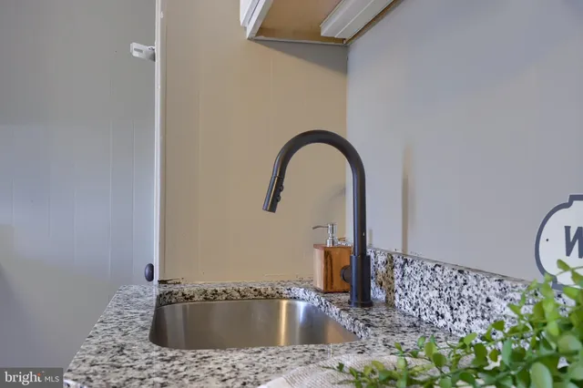 a kitchen with white cabinets and appliances