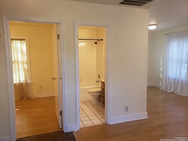 an empty room with a empty space and windows