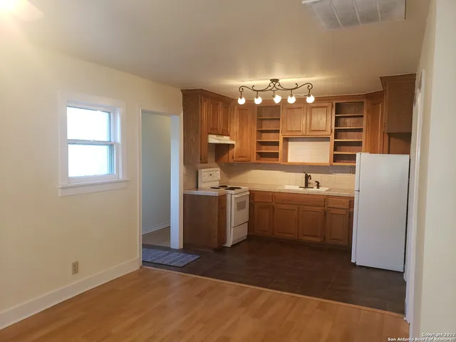 an empty room with windows and entrance