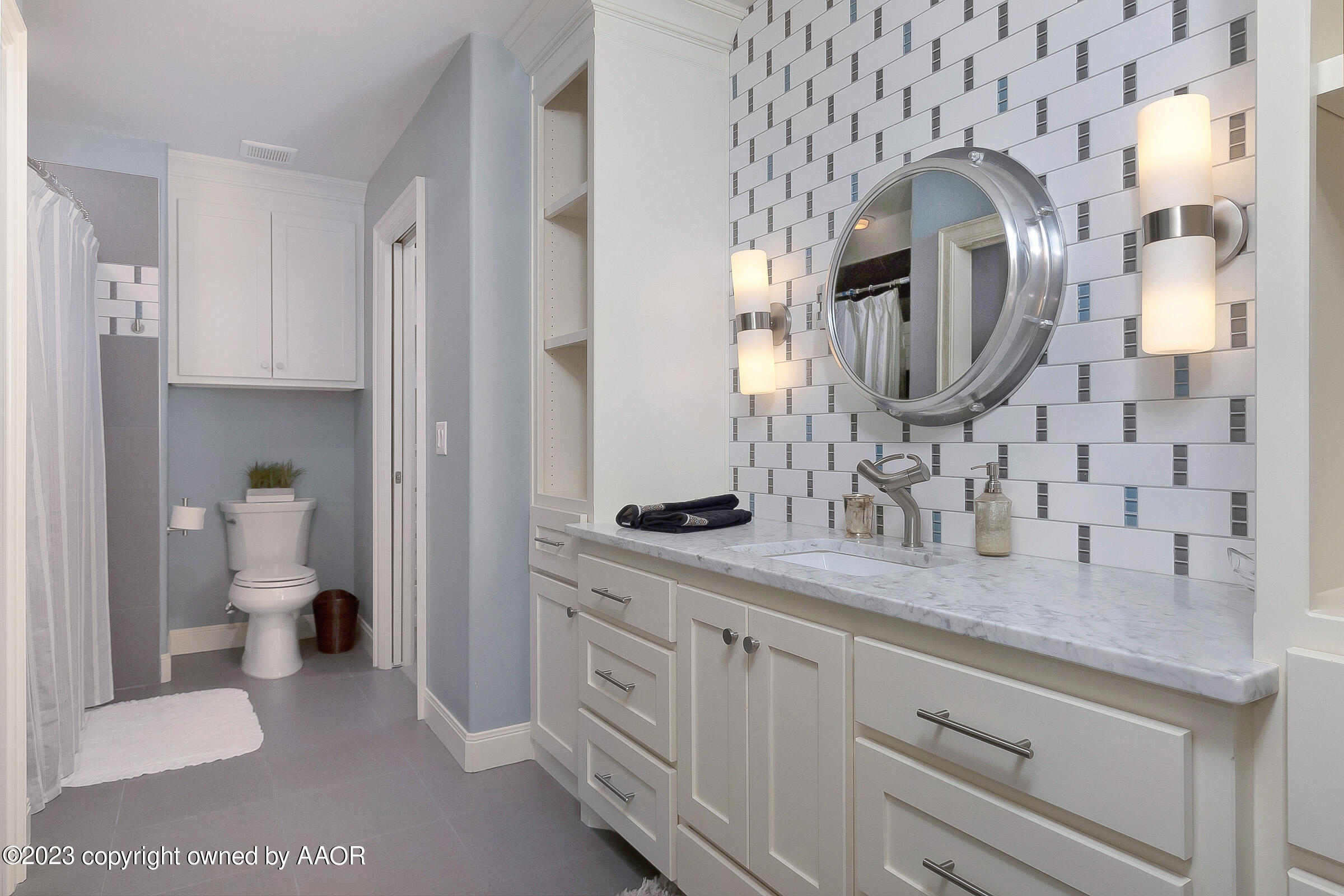 8100 Georgetown Drive Amarillo, TX 79119 - Photo 41 of 56 a en suite bathroom with a granite countertop sink and a mirror