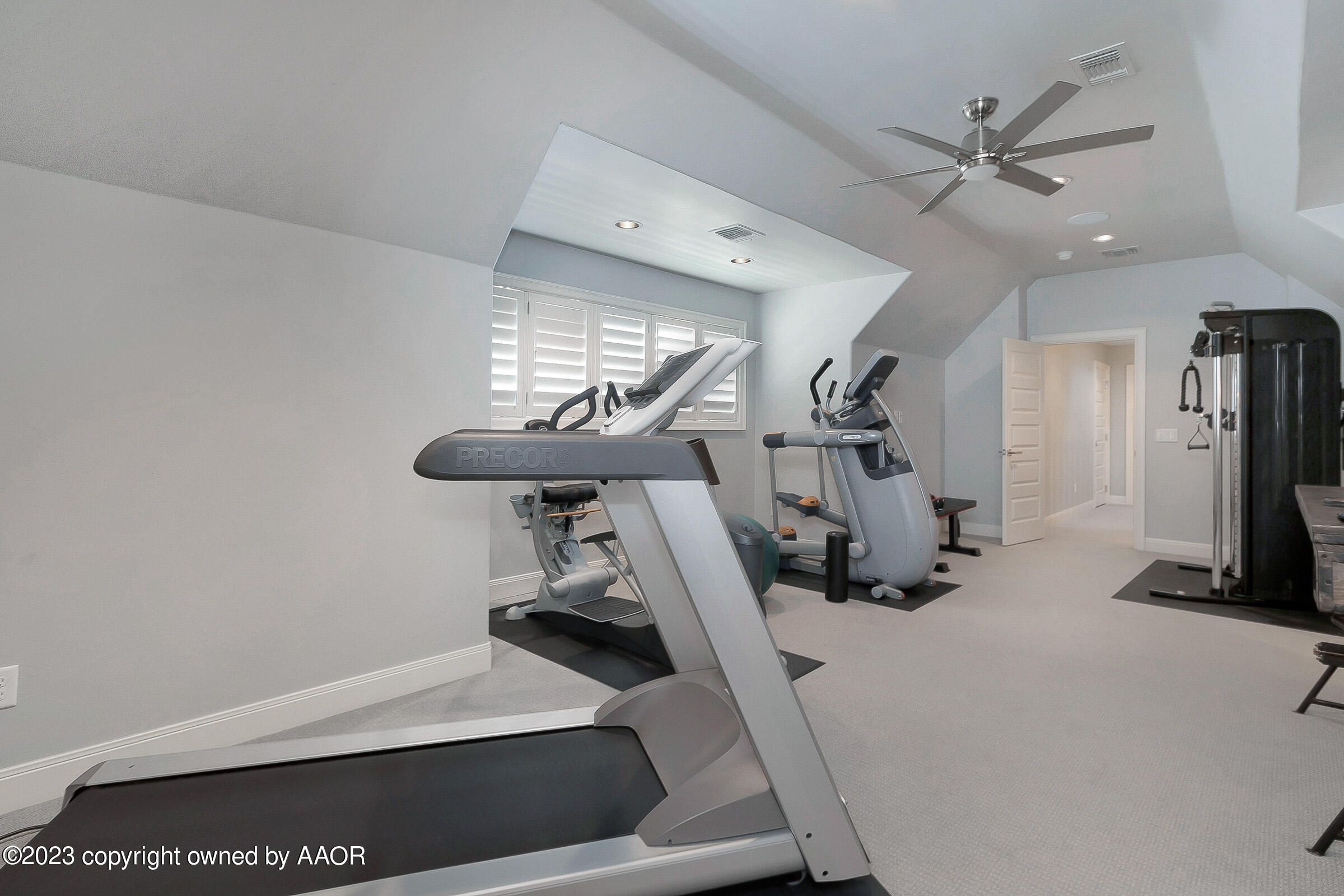 8100 Georgetown Drive Amarillo, TX 79119 - Photo 43 of 56 a room with gym equipment and a chandelier