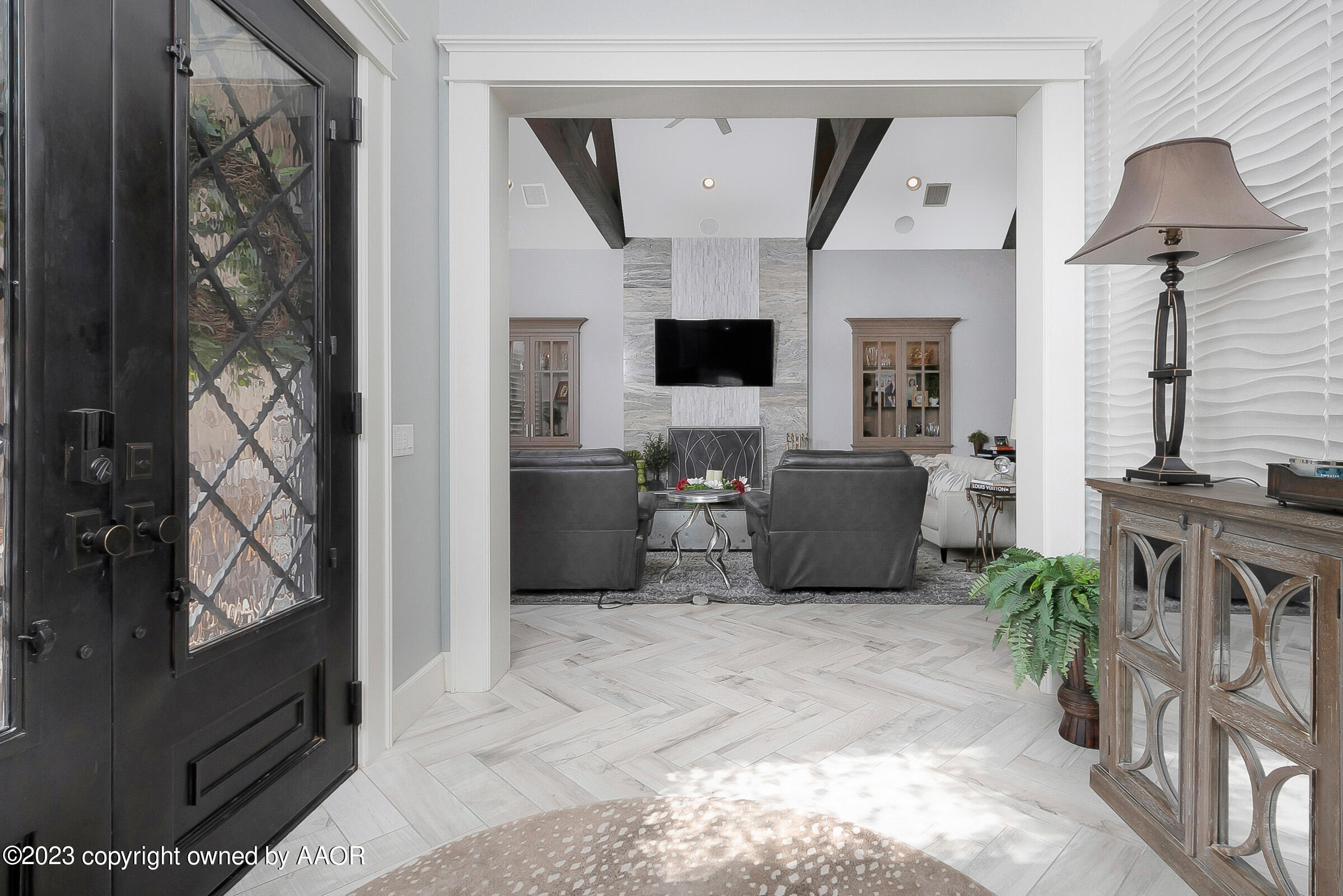 8100 Georgetown Drive Amarillo, TX 79119 - Photo 8 of 56 a living room with furniture a flat screen tv and a fireplace