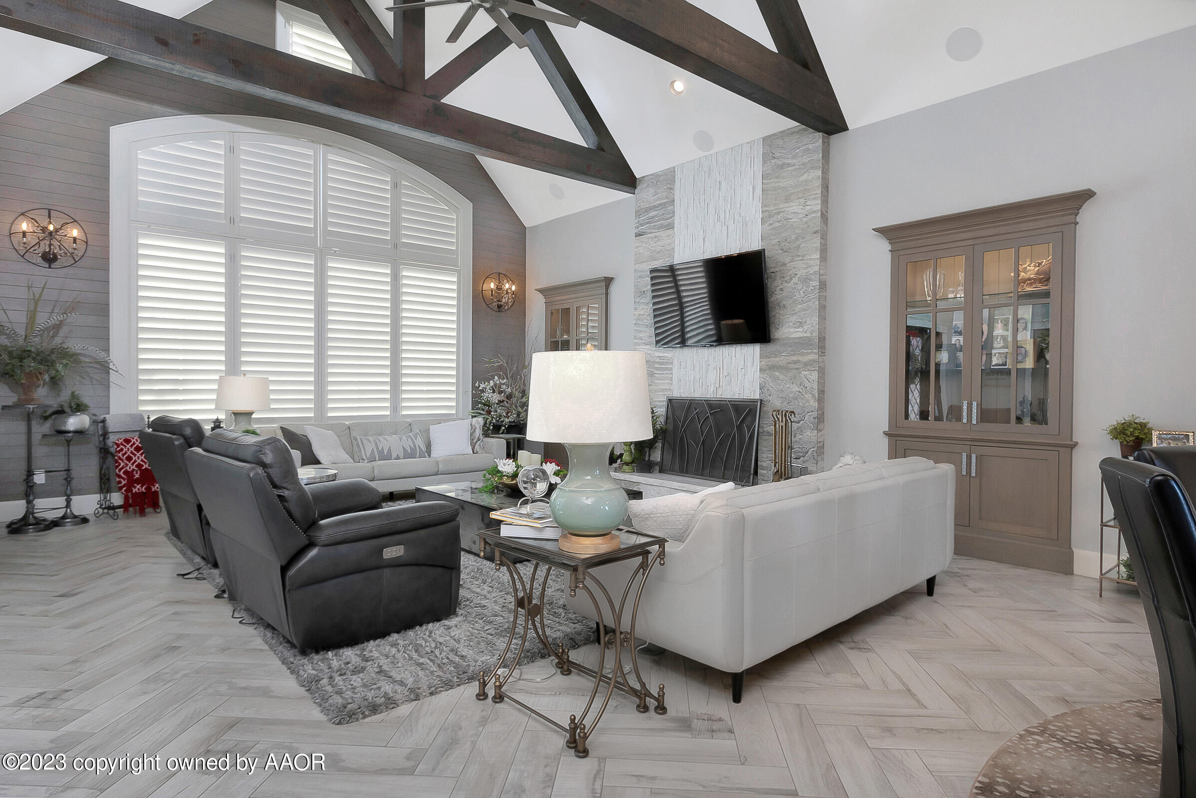 8100 Georgetown Drive Amarillo, TX 79119 - Photo 10 of 56 a living room with furniture a flat screen tv and a fireplace