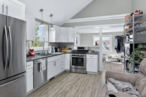 a kitchen with stainless steel appliances a refrigerator sink and microwave