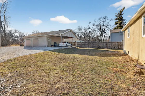 a view of a house with a yard and garage