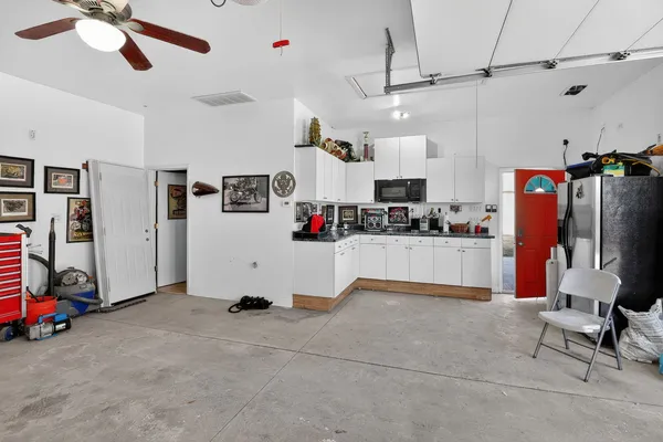 a view of kitchen with refrigerator and window