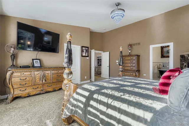 a bedroom with a bed and flat screen tv
