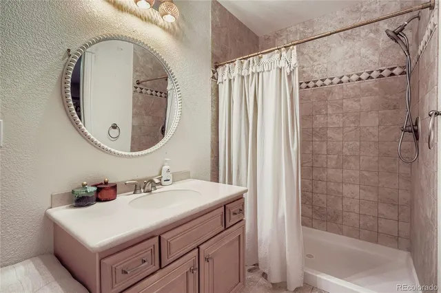 a bathroom with a sink vanity tub and a mirror